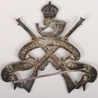 #40 – Cheltenham College Officers Training Corps, an ornate die-stamped silver coloured metal arm badge